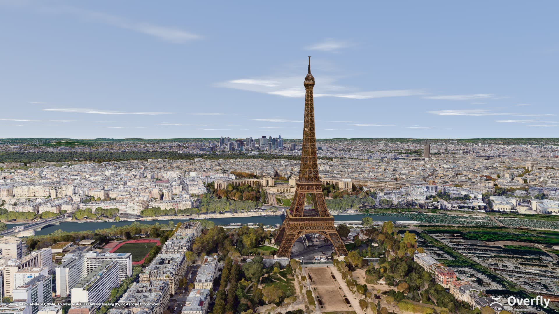 Overfly screenshot: the Eiffel Tower seen from a drone above the Champ de Mars, Paris